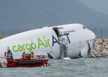 A cargo aircraft skids off a Hong Kong runway into the sea, killing 2 airport workers