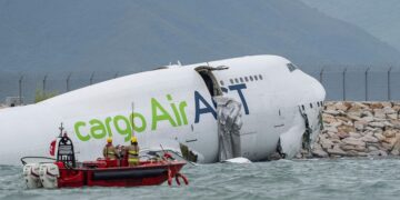 A cargo aircraft skids off a Hong Kong runway into the sea, killing 2 airport workers