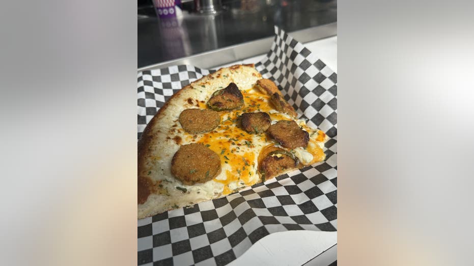 From cotton candy-covered bacon to mustard beer: The most unique eats at the 2025 State Fair of Texas 19 A pizza with fried pickles on a plate.