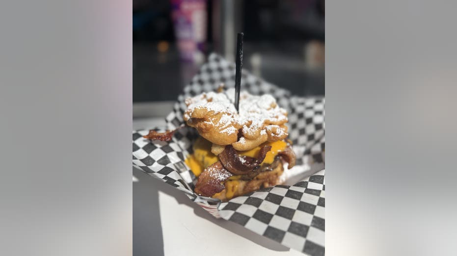 From cotton candy-covered bacon to mustard beer: The most unique eats at the 2025 State Fair of Texas 18 A grilled hamburger patty with crispy bacon and queso cheese sauce, sandwiched between two funnel cakes topped with powdered sugar.