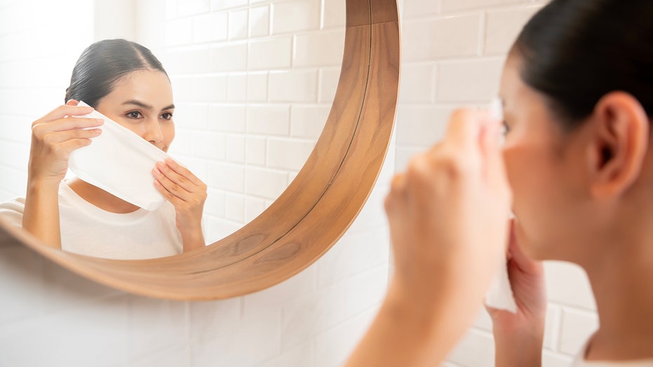 Neutrogena makeup wipes recalled across four states after bacteria found in product testing 5 Young woman cleaning removing makeup on her face in bathroom at home , beauty wellness concept