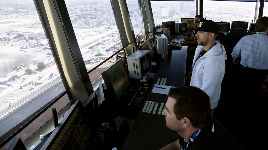 Air traffic controllers talk with pilots inside the control tower at Los Angeles International Airport (LAX) in Los Angeles, California